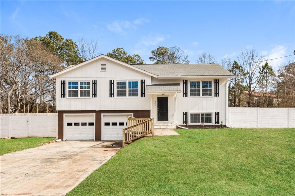 1885 Blanche Drive Douglasville, GA 30135 - Photo 1 of 1 a view of a house with a yard and table and chairs under an umbrella