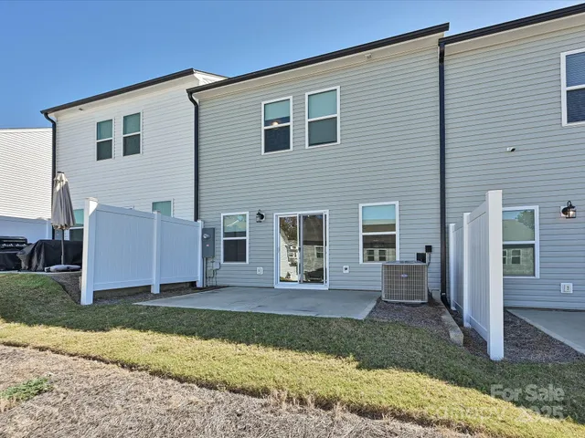 a front view of multiple houses with yard