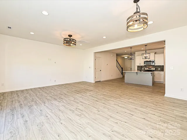 a view of a kitchen with a sink and a refrigerator