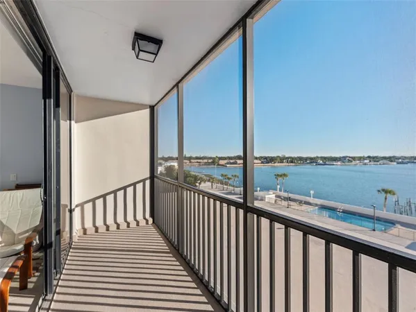 a view of a balcony with wooden floor and fence