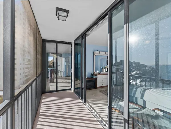 a bathroom with a glass door shower and a sink