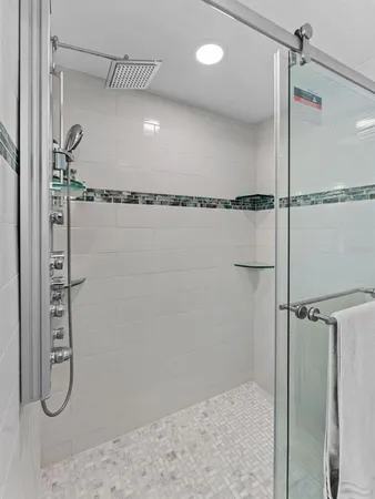 a bathroom with a glass shower door