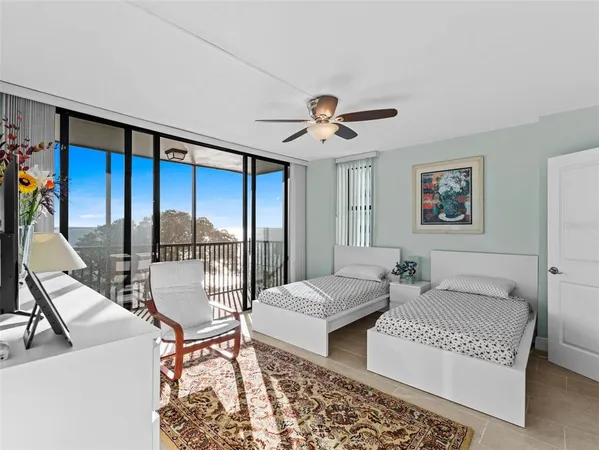 a living room with furniture and floor to ceiling window