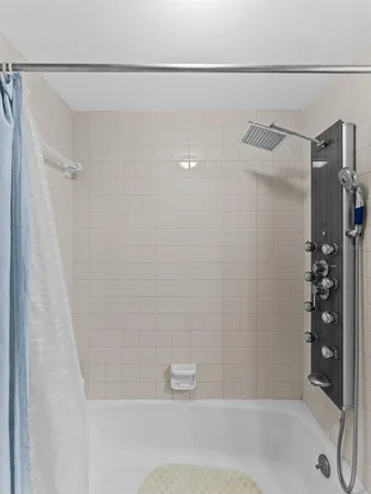a bathroom with a shower and a bath tub