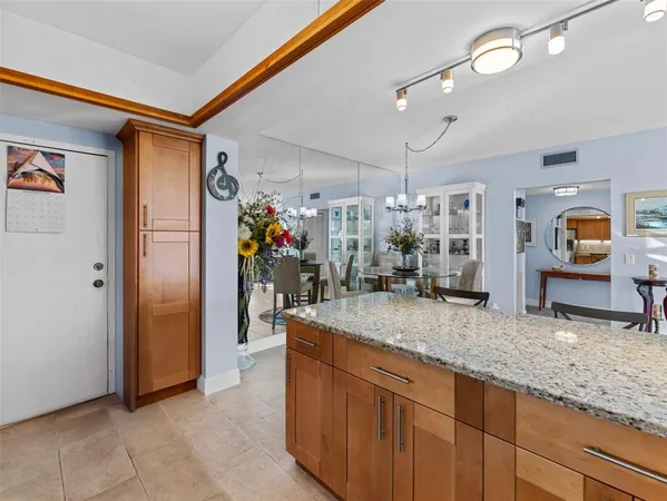 a bathroom with a granite countertop sink a mirror and shower