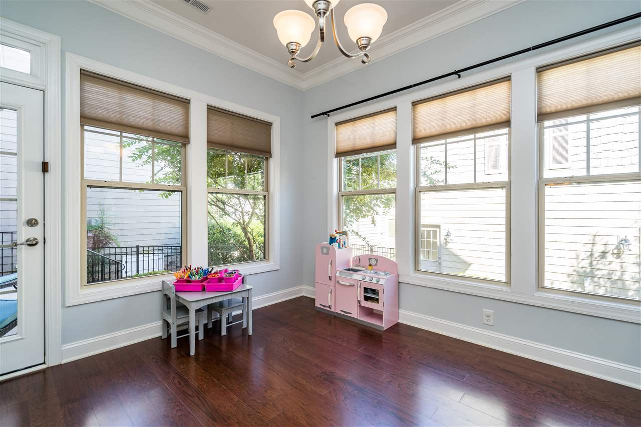 1411 Van Page Boulevard Raleigh, NC 27607 - Photo 15 of 26 Sunroom has three walls of windows and opens to the dining area with french doors. Also, step outside onto the back porch and patio with access from this door! Sunroom
