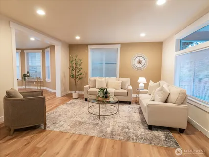 a living room with furniture and wooden floor