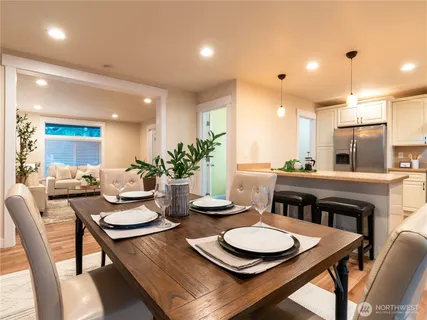 a dining room with furniture and wooden floor