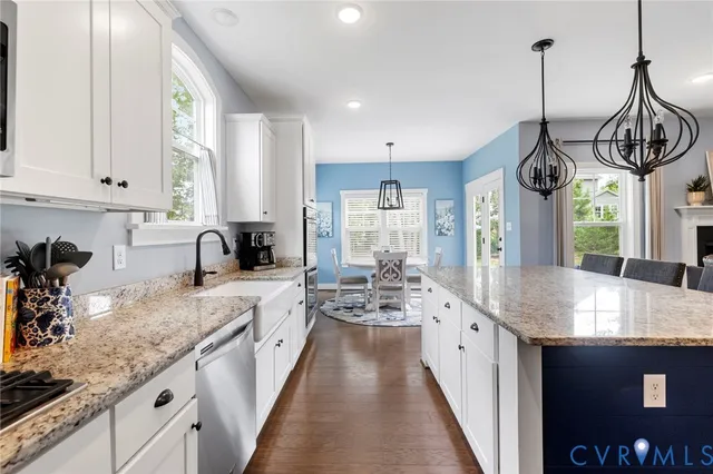 a kitchen with sink stove and window