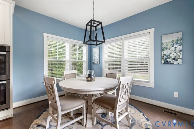 a dining room with furniture and window