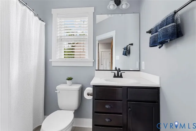 a bathroom with a toilet a sink and a mirror