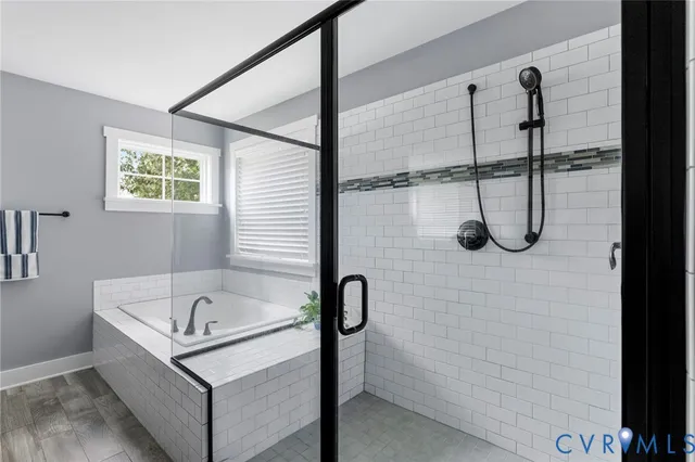 a bathroom with a bath tub and shower
