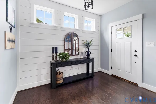 a room with painting on the wall and a window