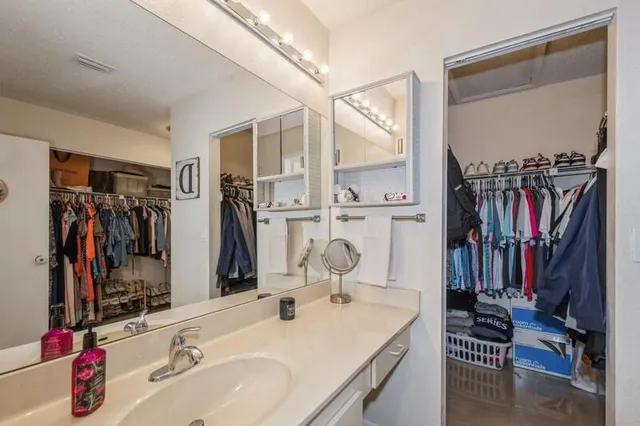 a bathroom with a sink double vanity and a mirror