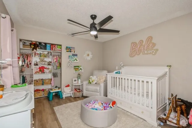 a bedroom with a baby crib and a couch