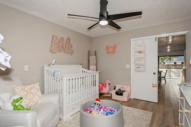 a bedroom with furniture a baby crib and a window