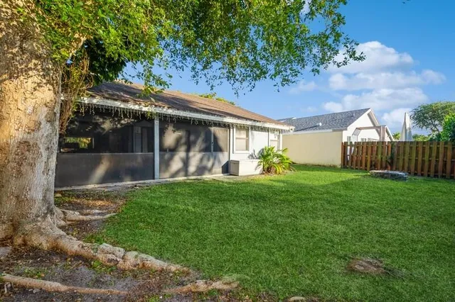 a green field with some trees in the background