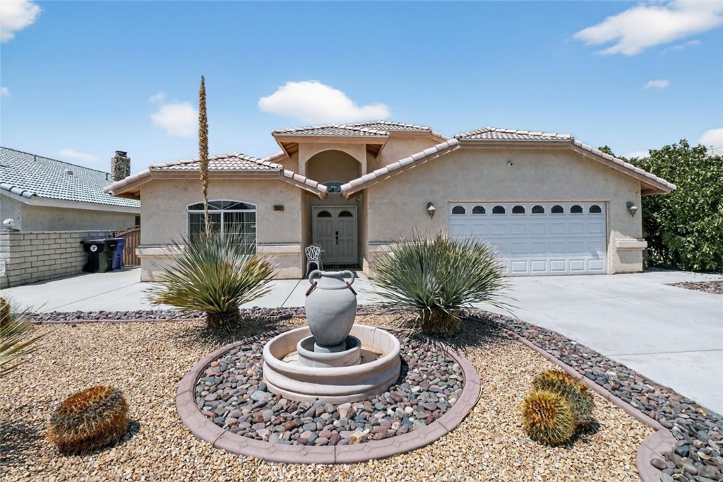 a front view of a house with a fountain