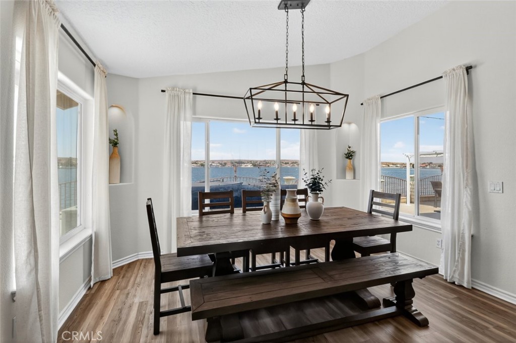26502 Bluewater Road Helendale, CA 92342 - Photo 17 of 30 a view of a dining room with furniture window and wooden floor