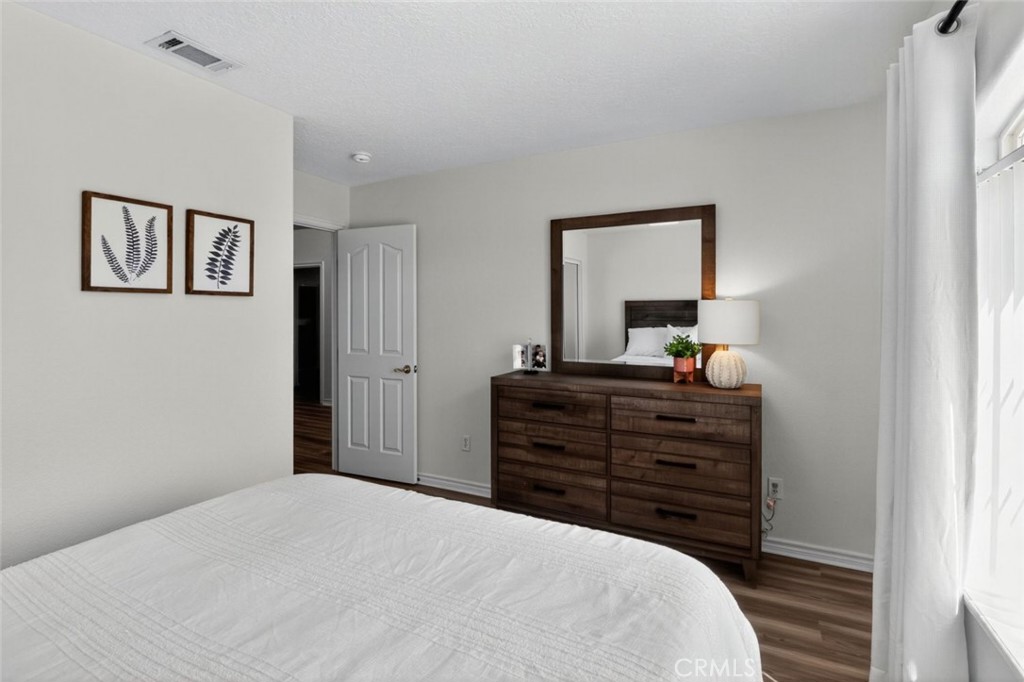 26502 Bluewater Road Helendale, CA 92342 - Photo 21 of 30 a bedroom with a bed and a mirror