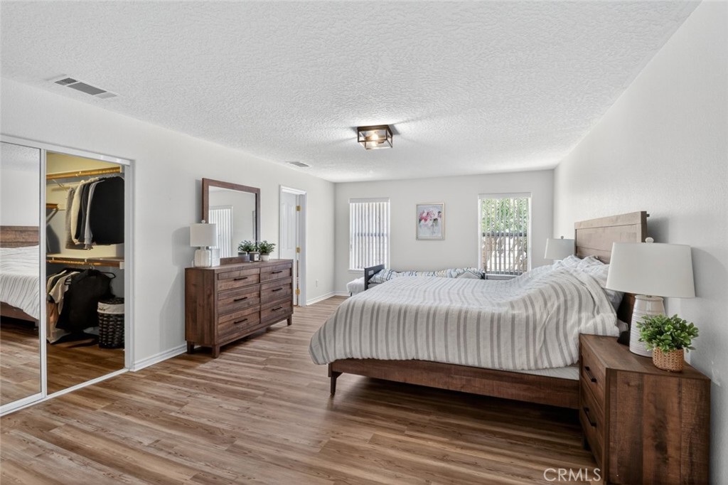 26502 Bluewater Road Helendale, CA 92342 - Photo 25 of 30 a bedroom with a bed and wooden floor