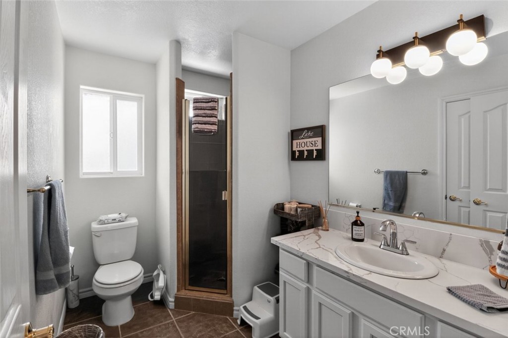 26502 Bluewater Road Helendale, CA 92342 - Photo 26 of 30 a bathroom with a toilet sink and mirror