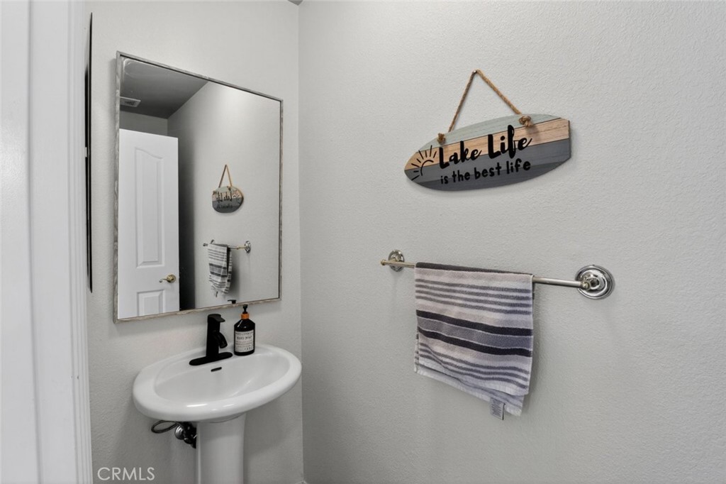 26502 Bluewater Road Helendale, CA 92342 - Photo 27 of 30 a bathroom with a sink and a mirror