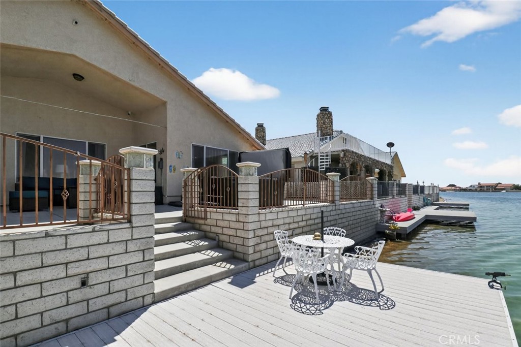 26502 Bluewater Road Helendale, CA 92342 - Photo 6 of 30 a view of a patio with dining table and chairs with wooden floor