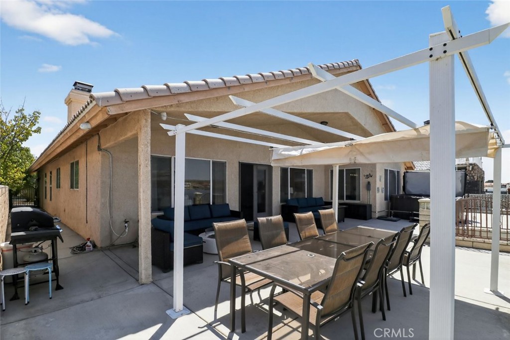26502 Bluewater Road Helendale, CA 92342 - Photo 9 of 30 a view of a dinning table and chairs in the patio