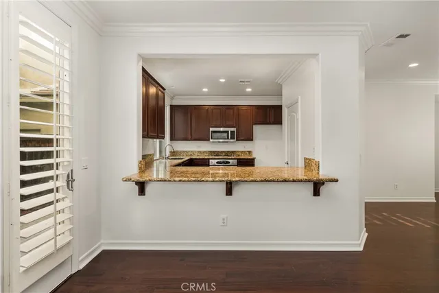 a view of kitchen with sink microwave and stove