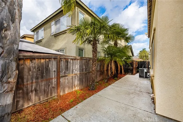 a view of entryway with wooden floor and a lots of palm trees
