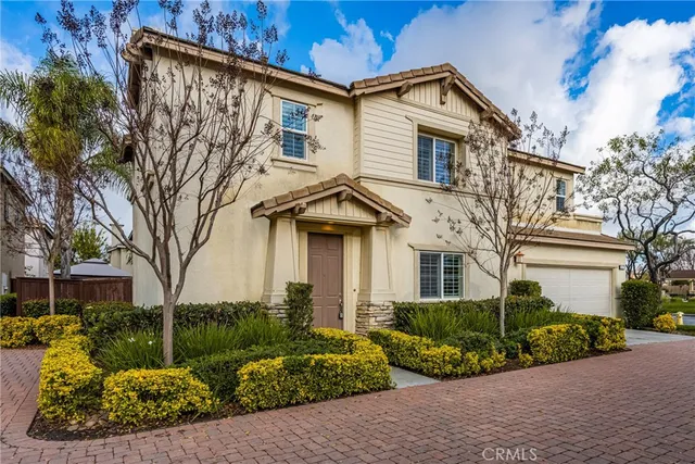 a front view of a house with a yard and outdoor seating