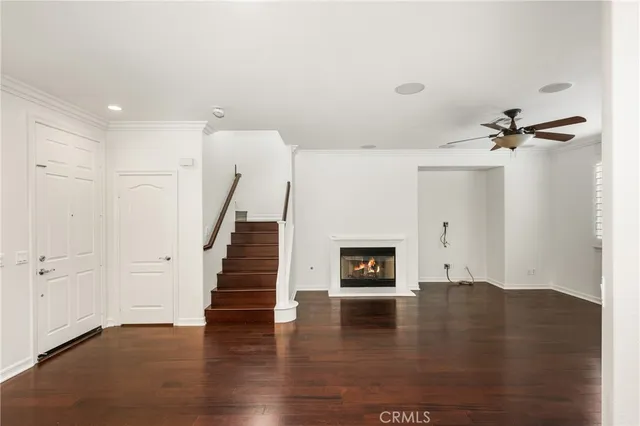 a view of a livingroom with wooden floor and a fireplace