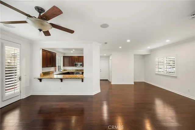 a view of livingroom with hardwood floor and a ceiling fan