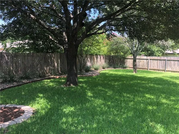 a front view of a house with a garden and yard