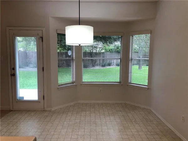 a view of a kitchen with a refrigerator a microwave and wooden floor