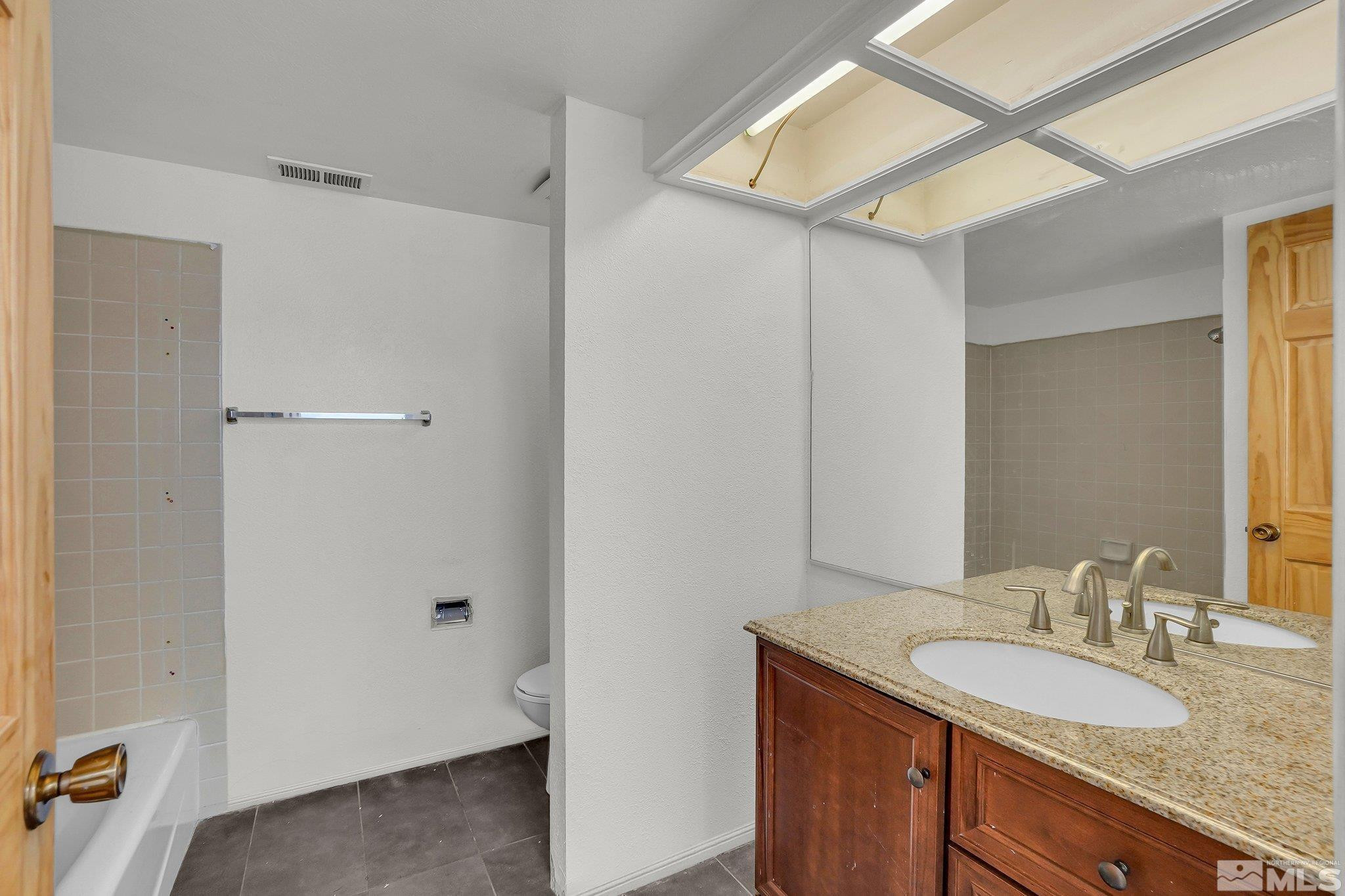 4185 Baker Lane Reno, NV 89509 - Photo 13 of 21 a bathroom with a granite countertop sink and a mirror