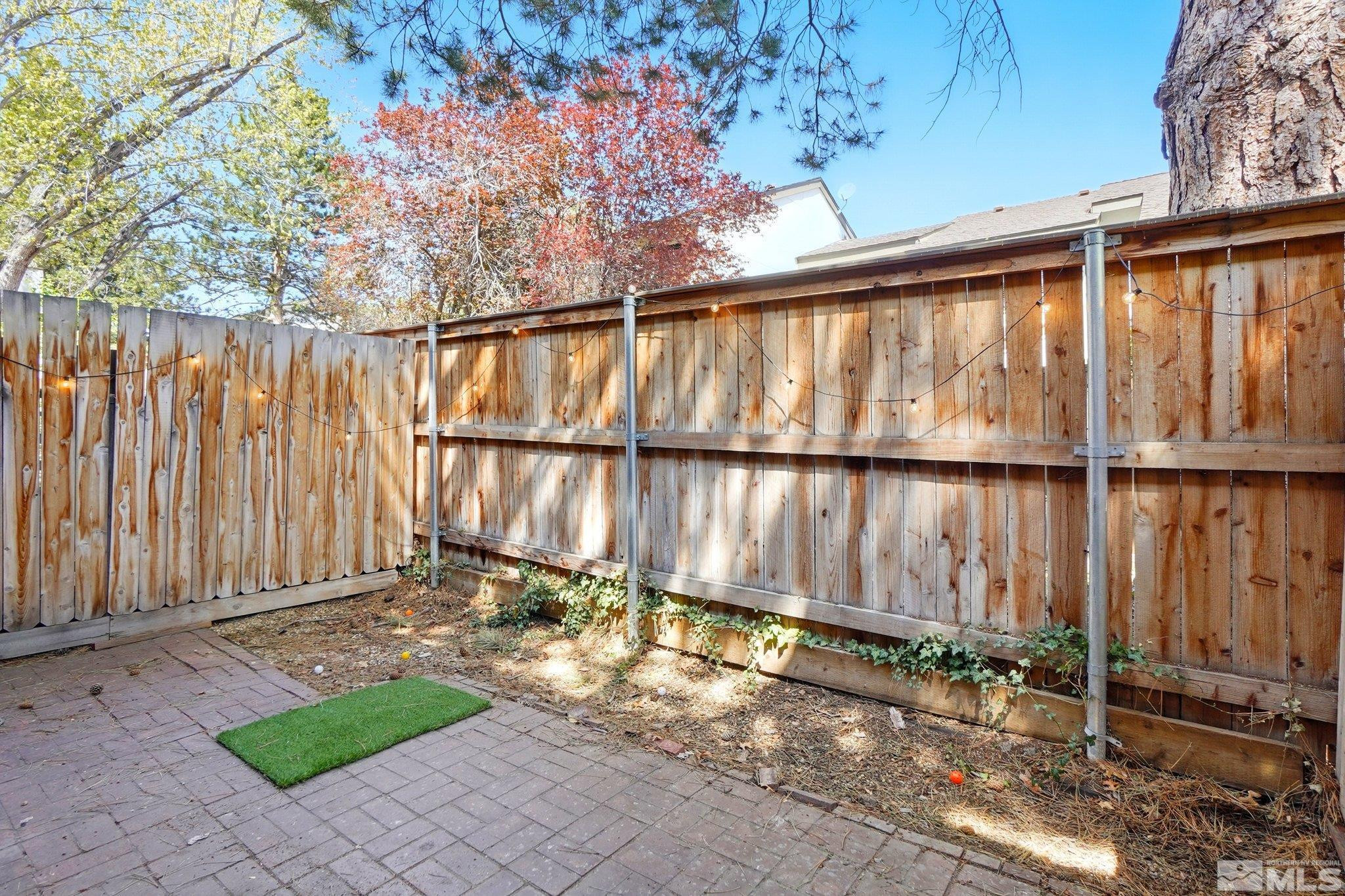 4185 Baker Lane Reno, NV 89509 - Photo 18 of 21 a view of a small yard with wooden fence