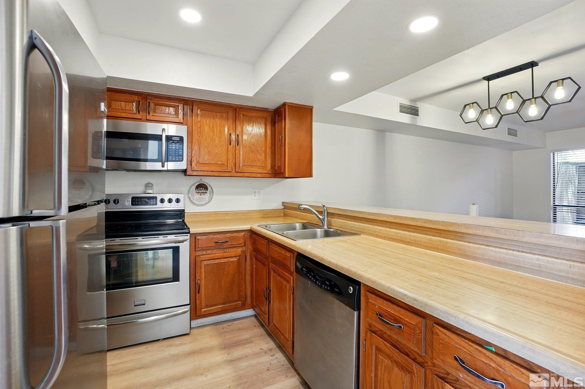 4185 Baker Lane Reno, NV 89509 - Photo 2 of 21 a kitchen with a stove microwave and sink