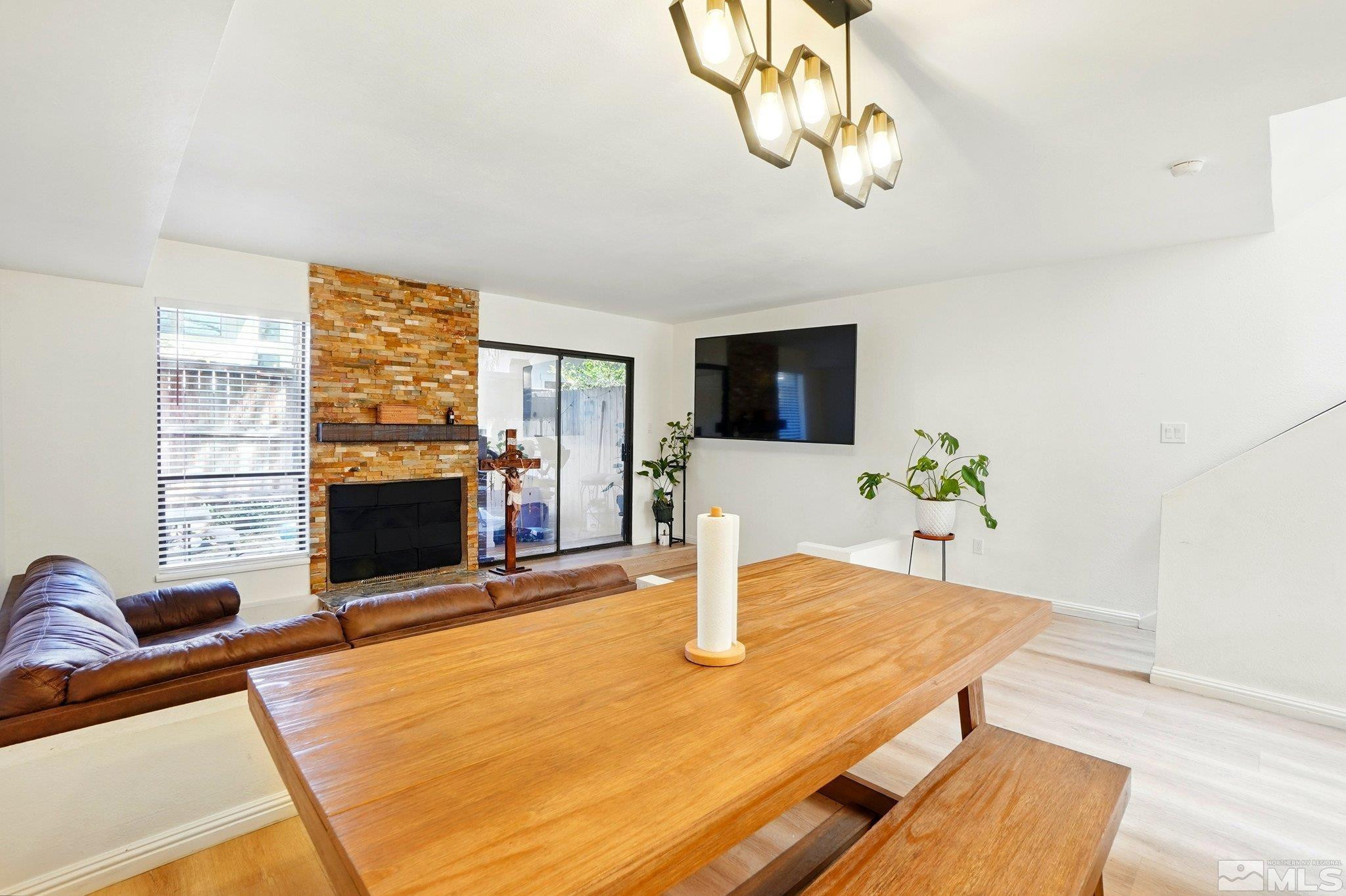 4185 Baker Lane Reno, NV 89509 - Photo 6 of 21 a living room with furniture a fireplace and a flat screen tv