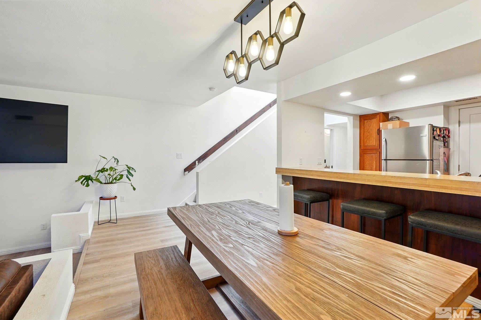 4185 Baker Lane Reno, NV 89509 - Photo 7 of 21 a living room with a table chairs and a wooden floor