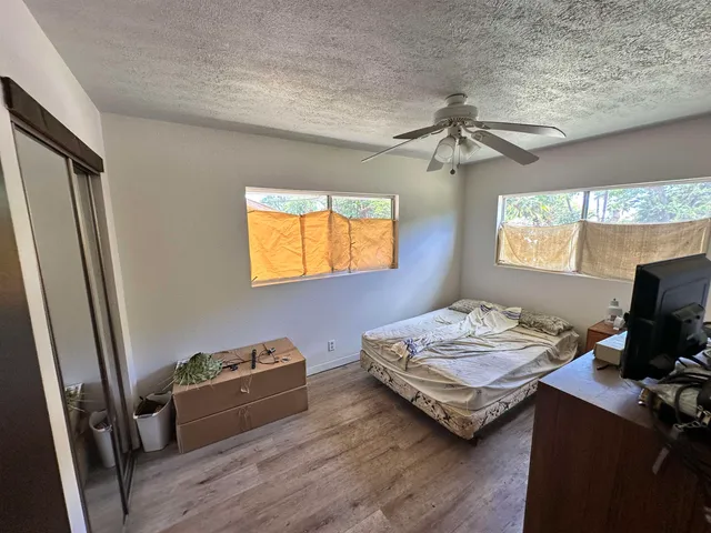a view of workspace with wooden floor windows