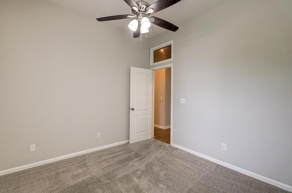 3235 Rall Avenue Clovis, CA 93619 - Photo 22 of 33 an empty room with closet and a chandelier fan