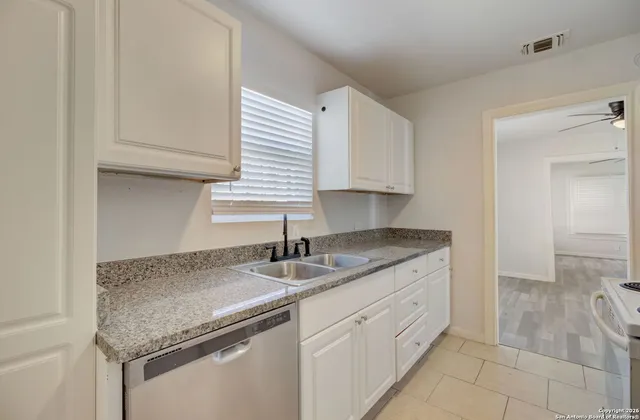 a kitchen with a sink and cabinets