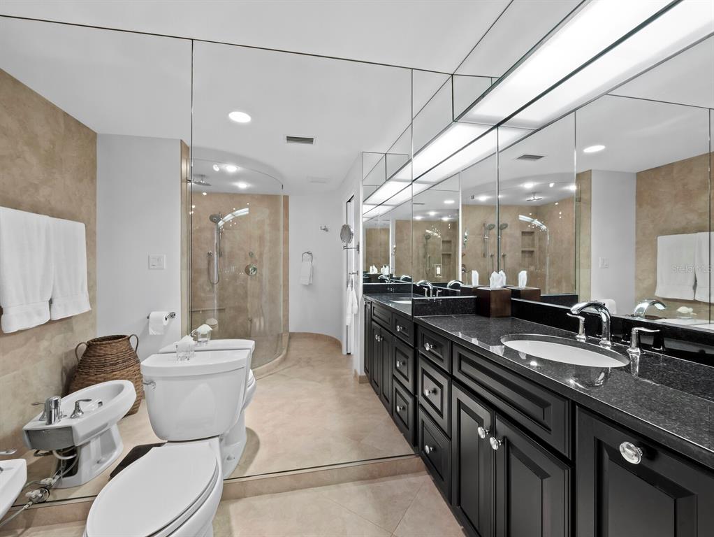 455 Longboat Club Road, Unit 402 Longboat Key, FL 34228 - Photo 17 of 48 a bathroom with a granite countertop double vanity and a mirror