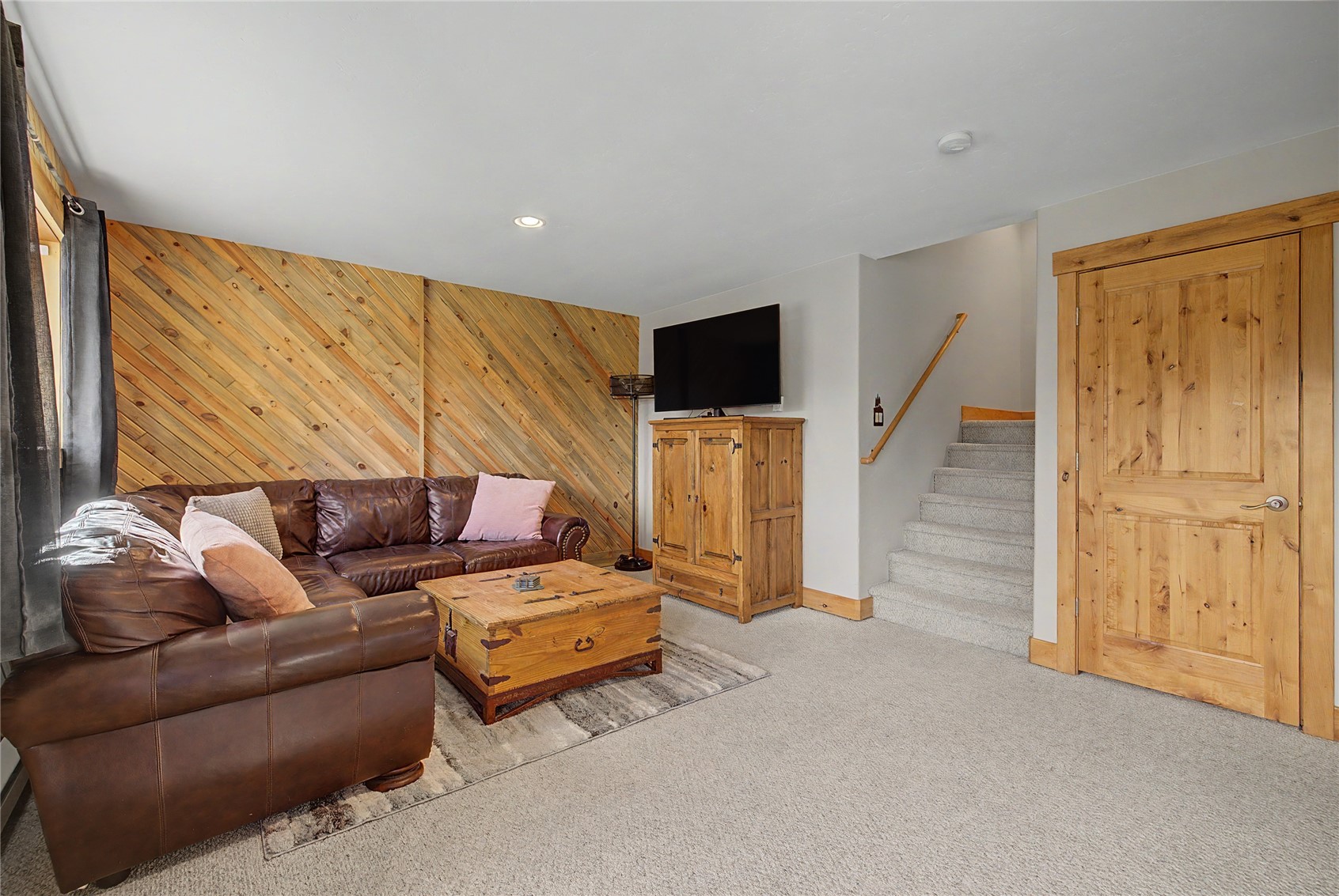 6726 Ryan Gulch Road, Unit 6726 Wildernest, CO 80498 - Photo 34 of 39 a living room with furniture and a flat screen tv