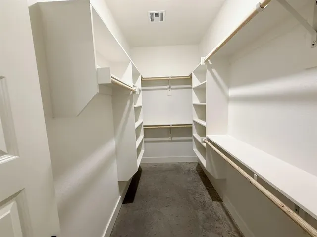 a bathroom with a granite countertop toilet a sink and a mirror