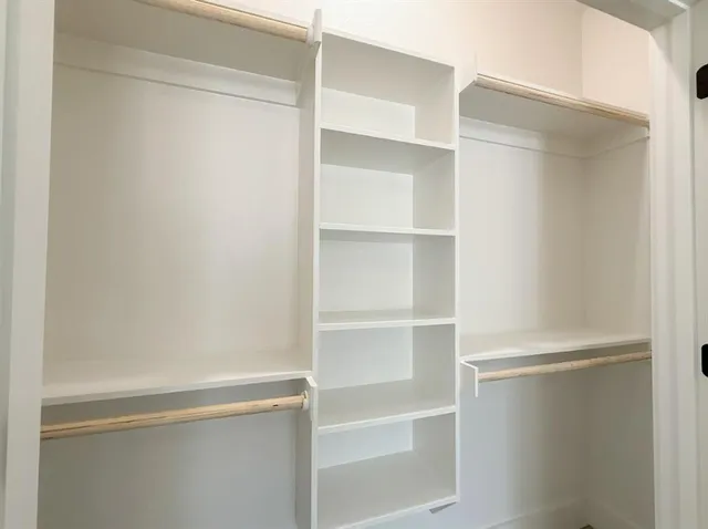 a view of an empty room with a ceiling fan