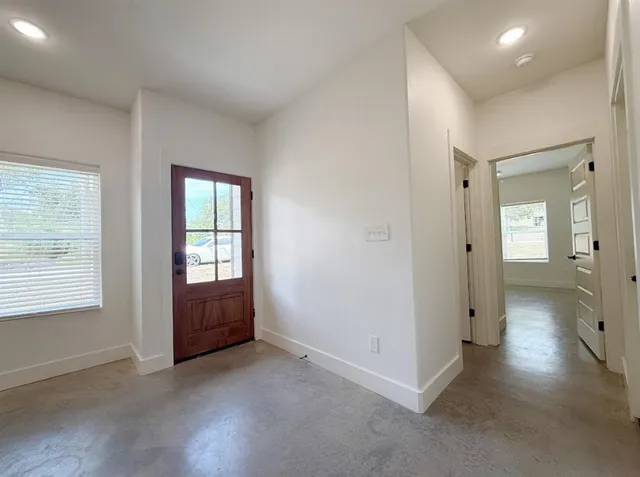 an empty room with windows and closet