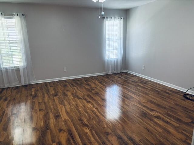 402 Juniper Street Destin, FL 32541 - Photo 10 of 20 an empty room with wooden floor and windows